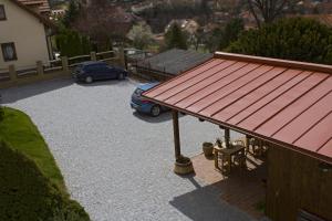 a car parked in a parking lot with a red roof at 1st Republic Villa - Adults only in Český Krumlov