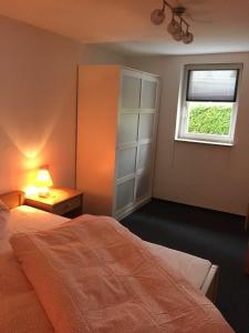 a bedroom with a bed and a window at Springer-Apartment-1215 in Kurort Oberwiesenthal