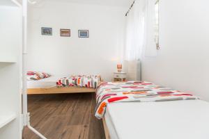 a bedroom with two beds and a window at Apartments Cekada in Labin