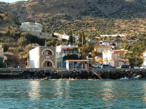 a view of a town from the water at Zea Waves apartments in Kastrí