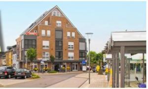 a large brick building on a city street at HIB Hotel in Baesweiler in Baesweiler