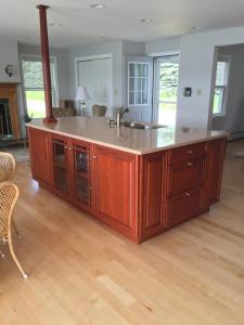 a kitchen with a large island with a sink at Claddagh Cottage in Richfield Springs