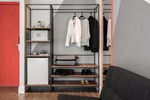 a walk in closet with a black closet organizer at Intercity Porto Alegre Praia de Belas in Porto Alegre