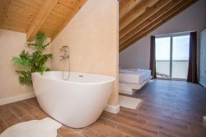 a bathroom with a white tub in a room at Captain's Attic in Račišće +27 photos