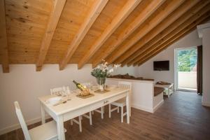 a dining room with a white table and wooden ceilings at Captain's Attic in Račišće