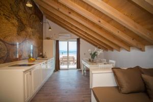 a kitchen and living room with a view of the ocean at Captain's Attic in Račišće