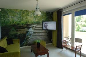 a living room with a painting of a wooden bridge at M&K Apartamenty - Słoneczne Tarasy I in Gdańsk