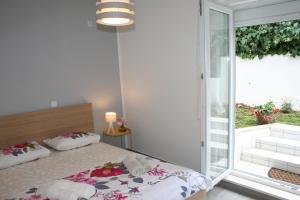 a bedroom with a bed and a sliding glass door at Room with garden in Split