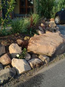 a rock garden in front of a house at Ferienhaus Pfaffensee in Harthausen +8 photos