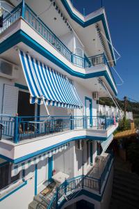 a view of a building with blue and white balconies at Kaskanis Apartments in Vráchos