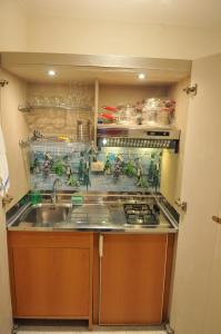 a kitchen with a sink and a stove at Archivio dei Ricordi - Casa con vista a Ostuni in Ostuni