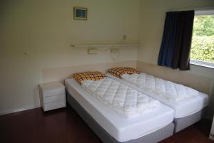 Postel nebo postele na pokoji v ubytování Dunopark Bungalow
