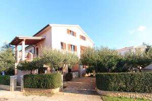 a white house with trees in front of it at Guest House Ljubica in Medulin