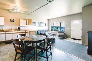 a kitchen and dining room with a table and chairs at The Waterfront at Potlatch in Shelton