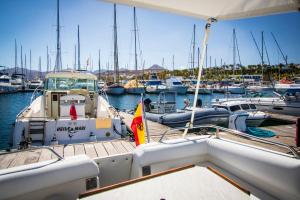 a boat docked in a marina with other boats at Cozy boat to unwind by the ocean in Puerto Calero +11 photos