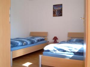 two beds sitting next to each other in a room at Ferienhäuschen in Born