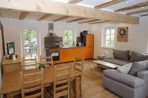 a kitchen and living room with a couch and a table at Altes -Haus in Gattendorf