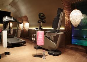 a room with a gym with a treadmill and a tv at La Maison Favart in Paris