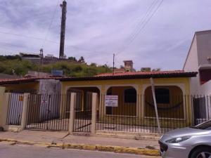 a yellow house with a fence in front of it at Casa Centro de Maragogi in Maragogi