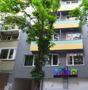 een gebouw met een wissota bord ervoor bij Visito Aparthouse in Sofia