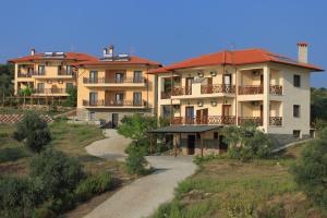 a group of houses on a hill with a road at Athorama Hotel in Ouranoupoli