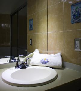 a bathroom with a sink and a towel on a counter at Hotel San Jorge in Santa Rosa de Copán