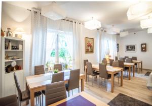 a dining room with tables and chairs and a window at Hubertus Rewal in Rewal