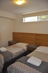 a room with two beds and a window at A Great Ocean View Motel in Apollo Bay
