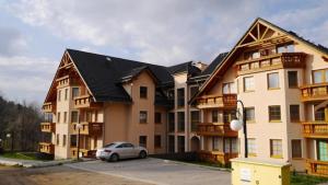 a car parked in front of a large building at Apartament Luna in Karpacz