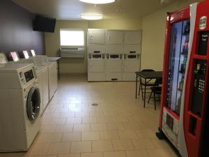 a kitchen with a washer and dryer in a room at Aspen Suites Hotel Sitka in Sitka