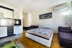 a bedroom with a bed and a couch at Zebra in Podgorica
