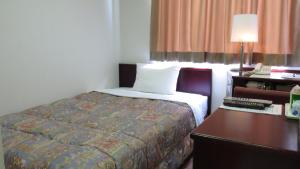 سرير أو أسرّة في غرفة في Hotel kakuban