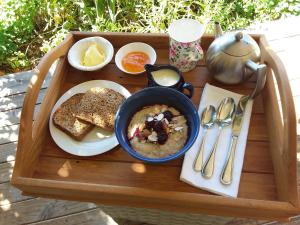 a tray of food with a bowl of soup and toast at Hurunui Homestead Bed and Breakfast in Hawarden +29 photos