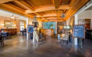 a room with tables and chairs and a chalkboard at Hotel Sutter in Sutter Creek