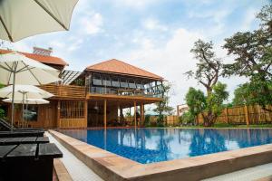 a house with a swimming pool in front of a building at Ong Lang Garden Resort in Phu Quoc