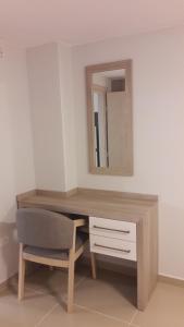 a desk with a mirror and a chair in a room at Casa Bella Deluxe Apartments in Palaiochora