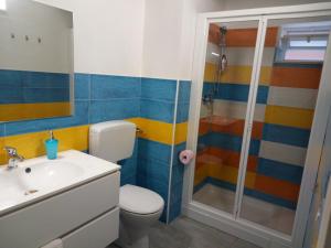 a bathroom with a shower and a toilet and a sink at Casammare in Marina di Modica