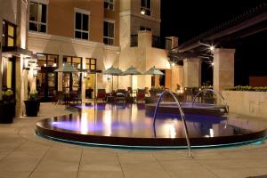 a swimming pool in a building at night at Hyatt Centric The Woodlands in The Woodlands