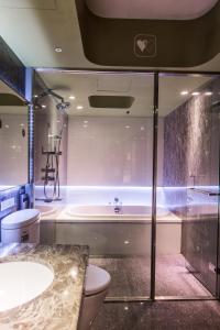 a bathroom with a tub and a toilet and a sink at inhouse Hotel in Taipei