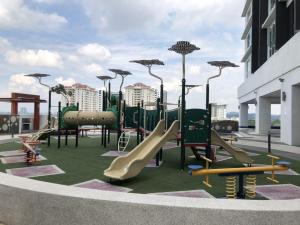 a playground with slides and play equipment on a building at Yenni Duplex @ DeCentrum, Kajang in Seri Kembangan