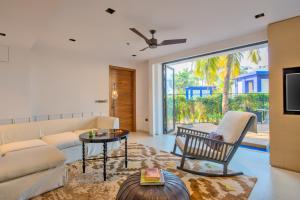 a living room with a couch and a table at Azaya Beach Resort Goa in Benaulim
