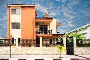 a house with a fence in front of it at Vila Patricia in Eforie Sud