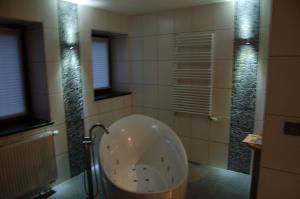a bath tub in a bathroom with a shower at Sy Select place in Ferrières +4 photos
