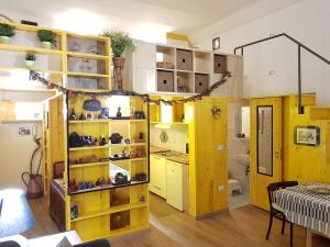 a room with a yellow cabinet with shelves at Graziella 27 in Naples