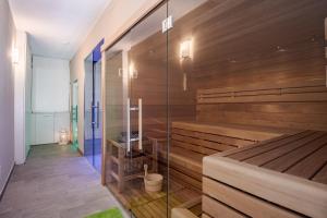 a sauna with wooden walls and a glass wall at Hotel Vischi in Domaso