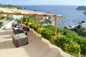 an outdoor patio with a view of the ocean at Maridea - La Procella in Ponza