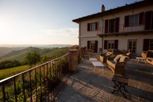 a house with a balcony with a view at Cascina Alberta in Treiso
