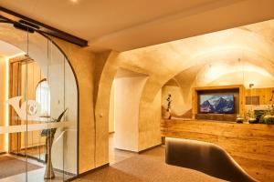 a living room with a glass wall at Hotel Post in Prutz