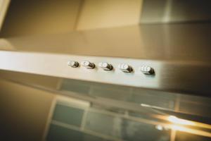 a row of control knobs on a stove at The Loft, Inverness in Inverness