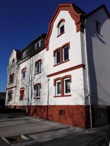 a white building with red accents on the side of it at Apartment Bad Homburg in Bad Homburg vor der Höhe